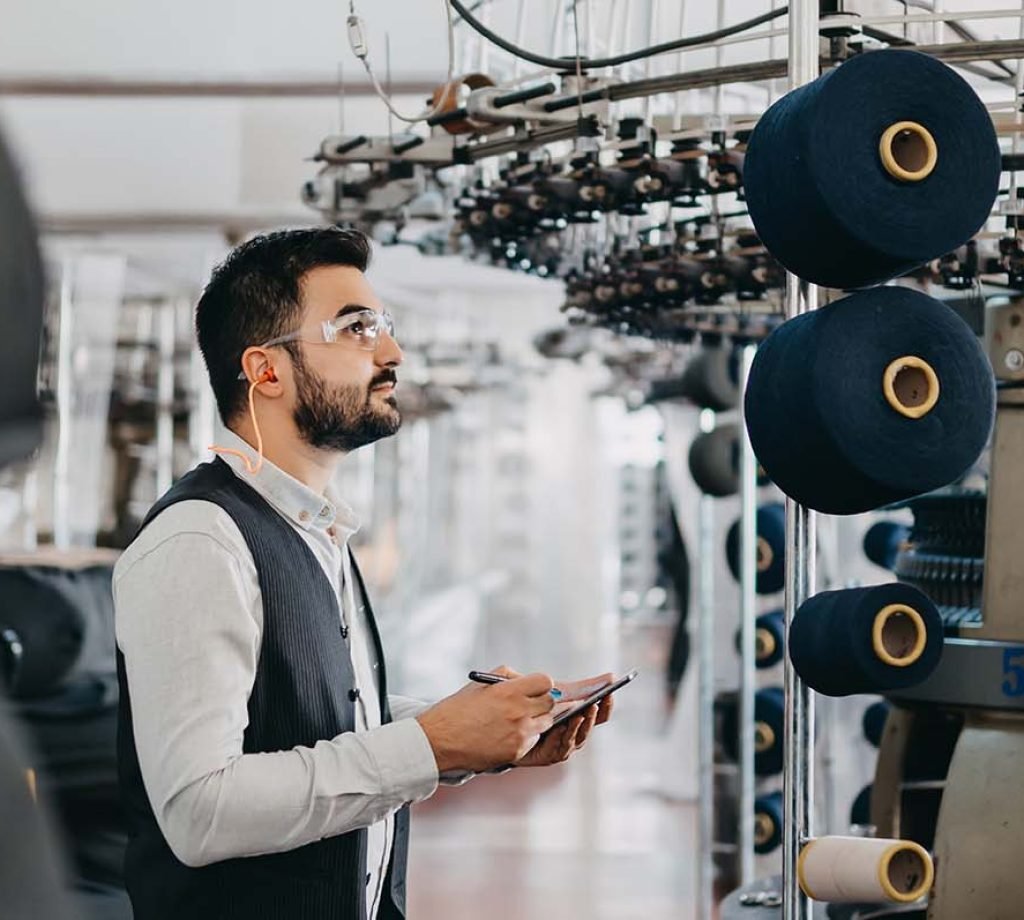 An expert invetigates the quality of the denim fabrics
